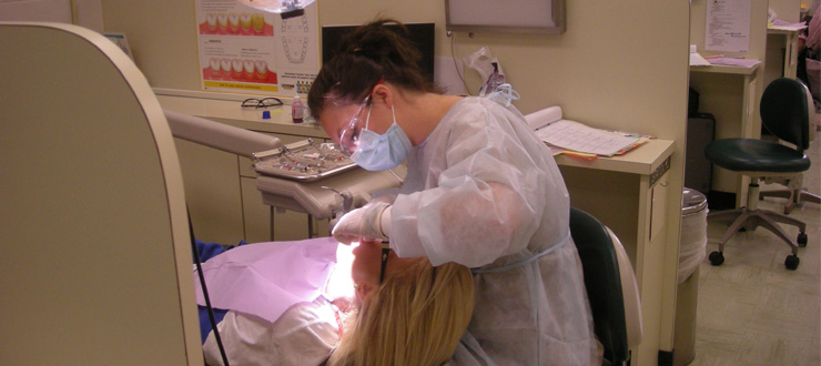 #caption3 Dental Hygiene student practices on fellow student in clinic
