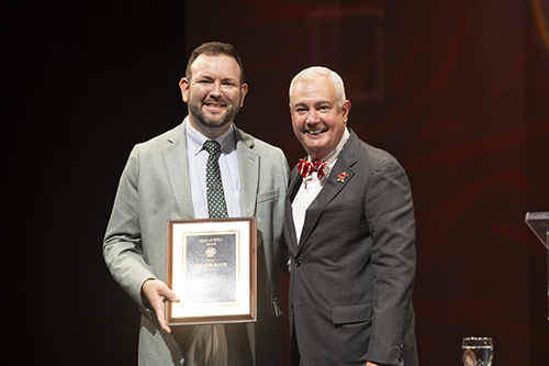 Bryson Davis, the 2025 Spirit of WKU Award Winner, poses for a photo with President Timothy C. Caboni at WKU Convocation