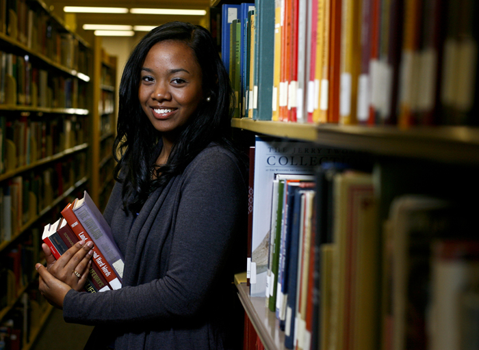 An Honors student stands in the library at WKU.