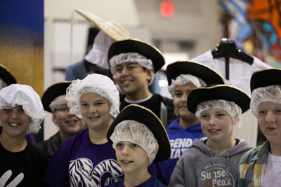 students wearing 18 century hats