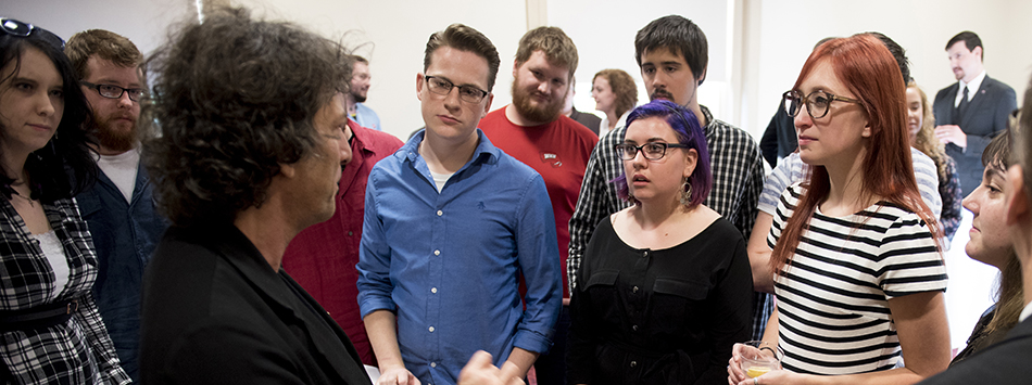 #caption5 Author Neil Gaiman greets WKU students before his on stage interview, photo by William Kolb