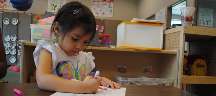 #caption2 Child coloring at table