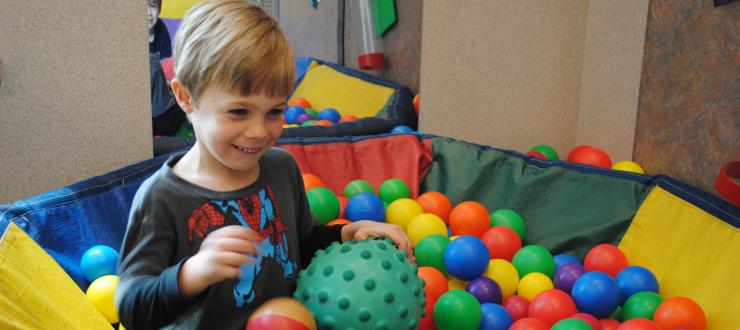 #caption3 Child playing in the ball pit