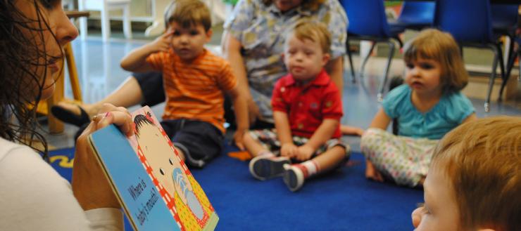 #caption7 children listening to a book at circle time