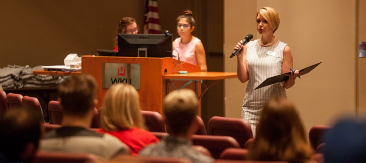 #caption4 Colette Chelf addresses student questions at the graduate orientation