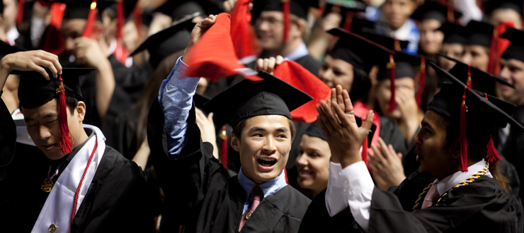 Graduation ceremony with student wearing international sash