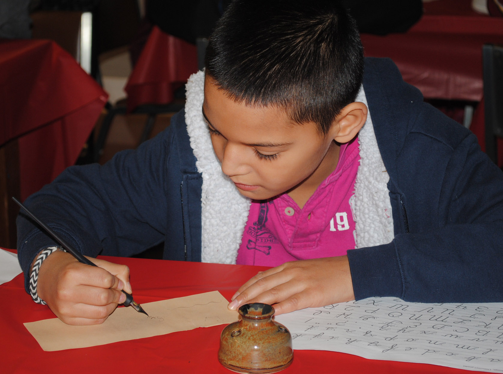 student writing with Civil War style pen