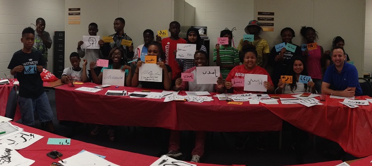 #caption3 Area high school students participate in a SWAG (Start with a Goal) event led by Arabic instructor, Lhousseine Guerwane (front row, right).