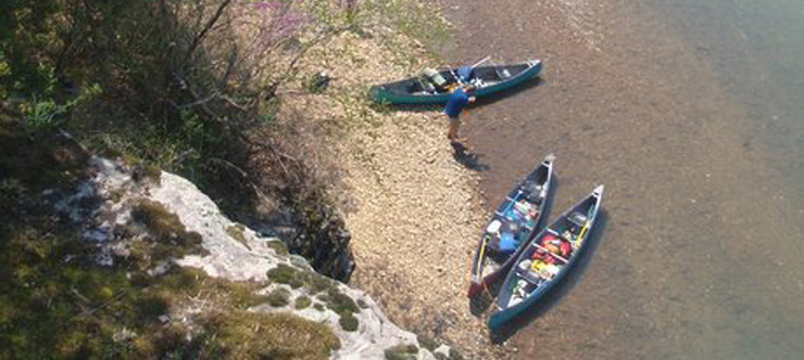 Canoes on a river bank