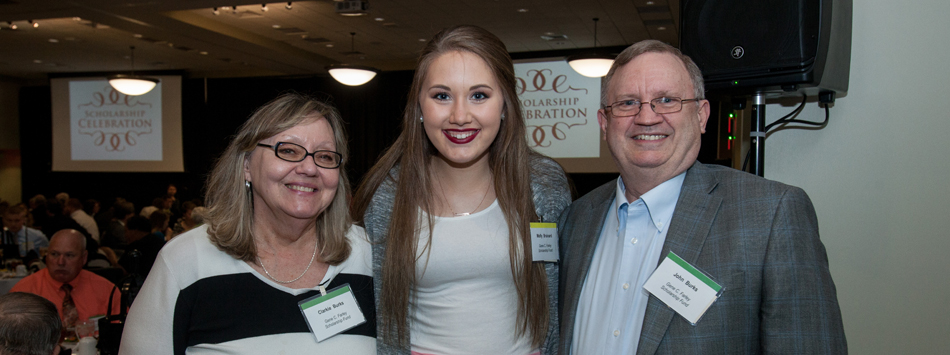 #caption1 Clarkie and John Burks pose with Molly Brainard, recipient of the Gene C. Farley Scholarship