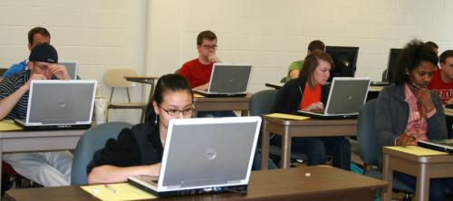 Accounting students studying with laptops.