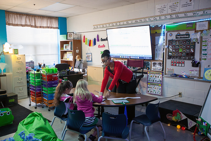 A teacher leading a class through an assignment.