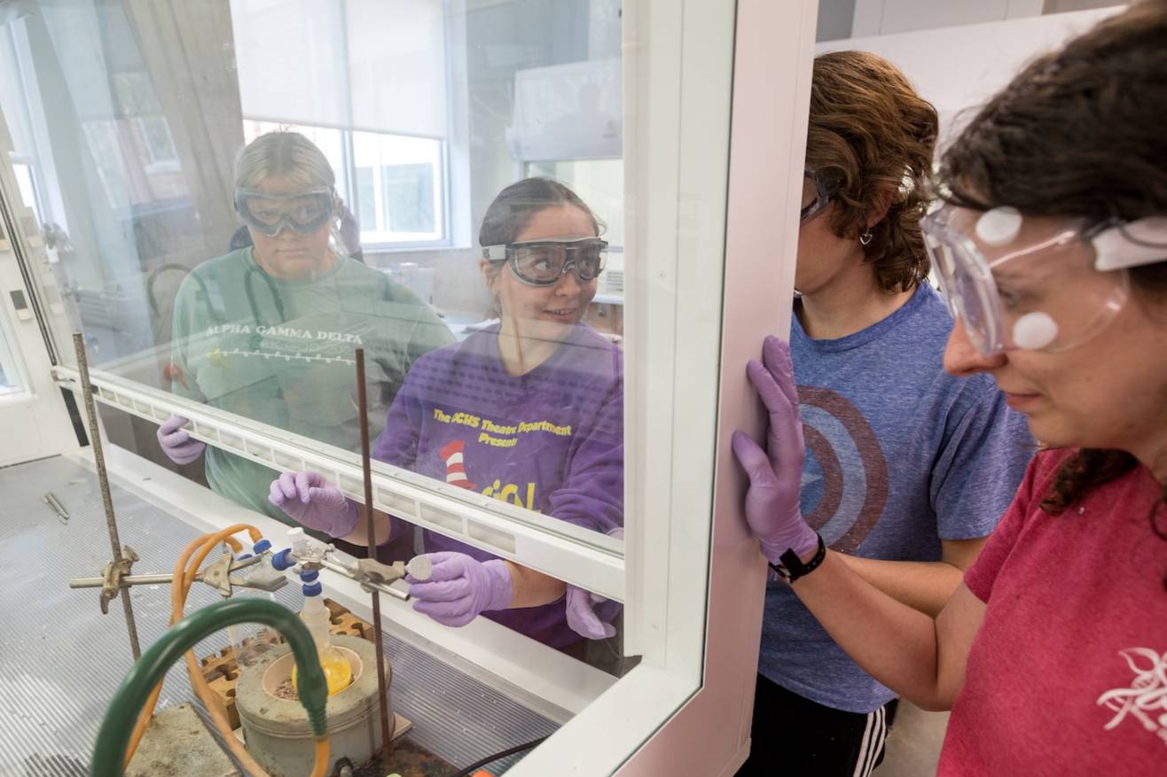 Four WKU students work together in a Chemistry lab.