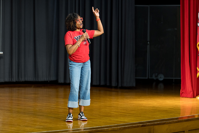 Doctoral graduate leading a speaking event. 