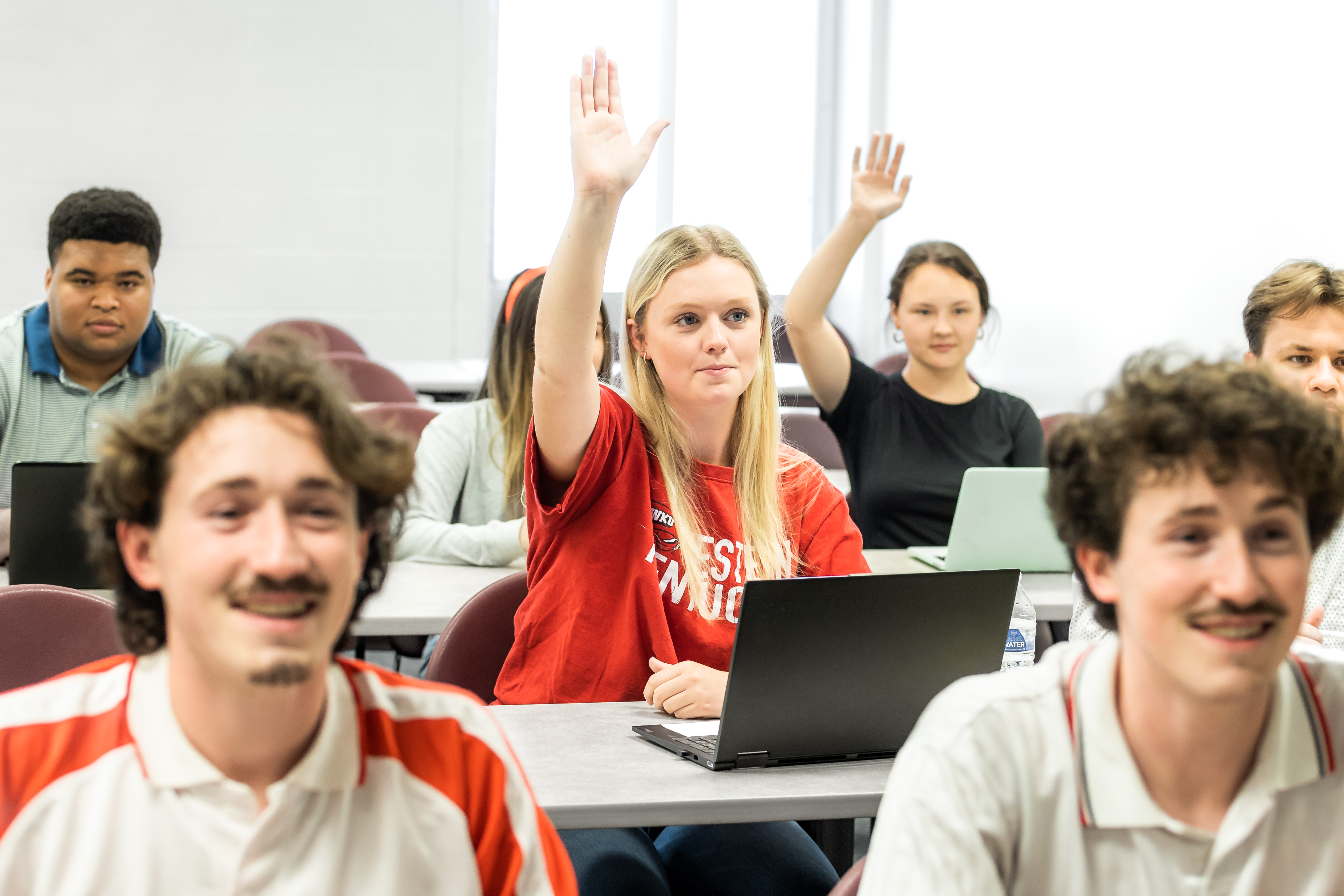 Student raises hand in class.