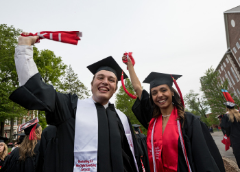 Graduates waving red towel