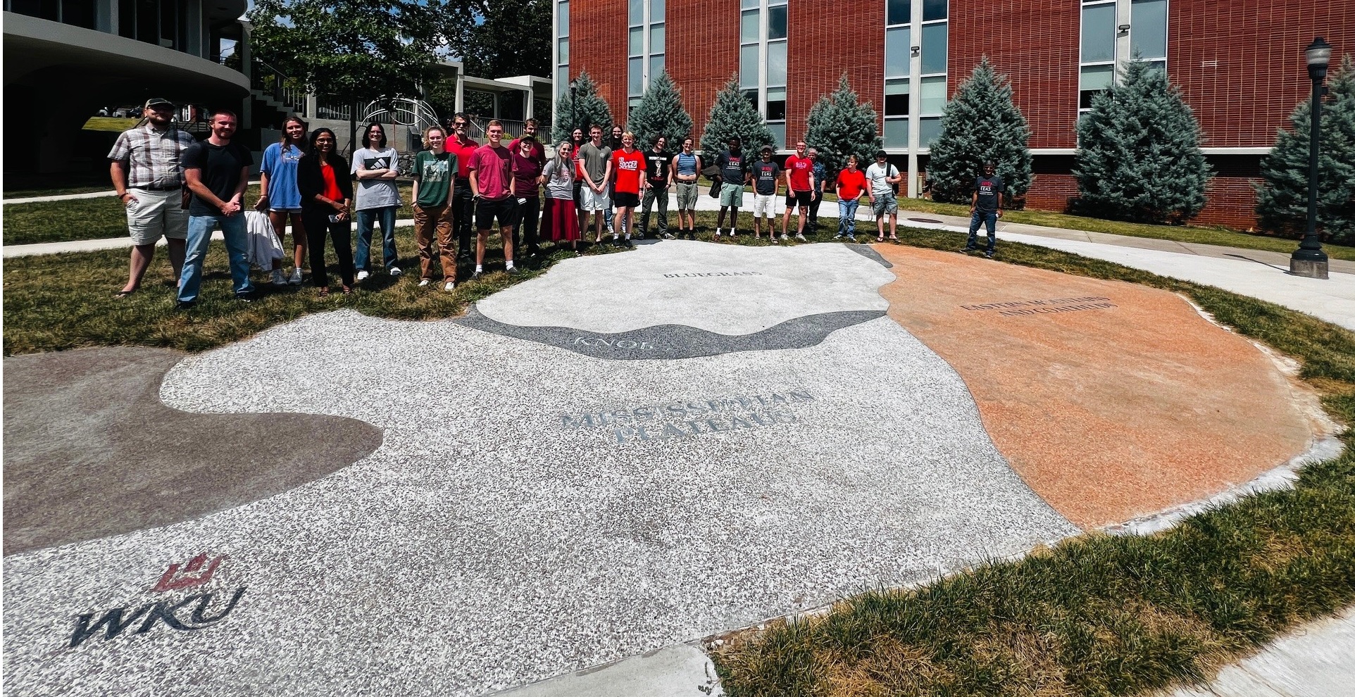 Students with rocks and stream