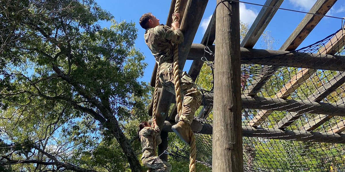 WKU ROTC LLC students going climbing over an obstacle