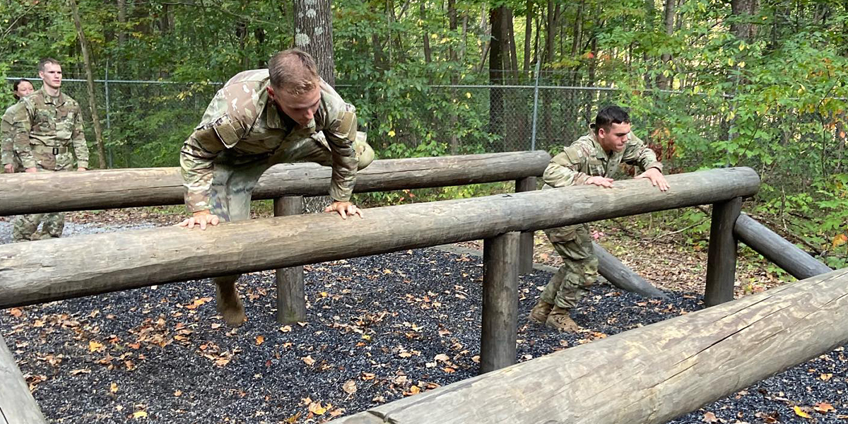 WKU ROTC LLC students jumping over an obstacle