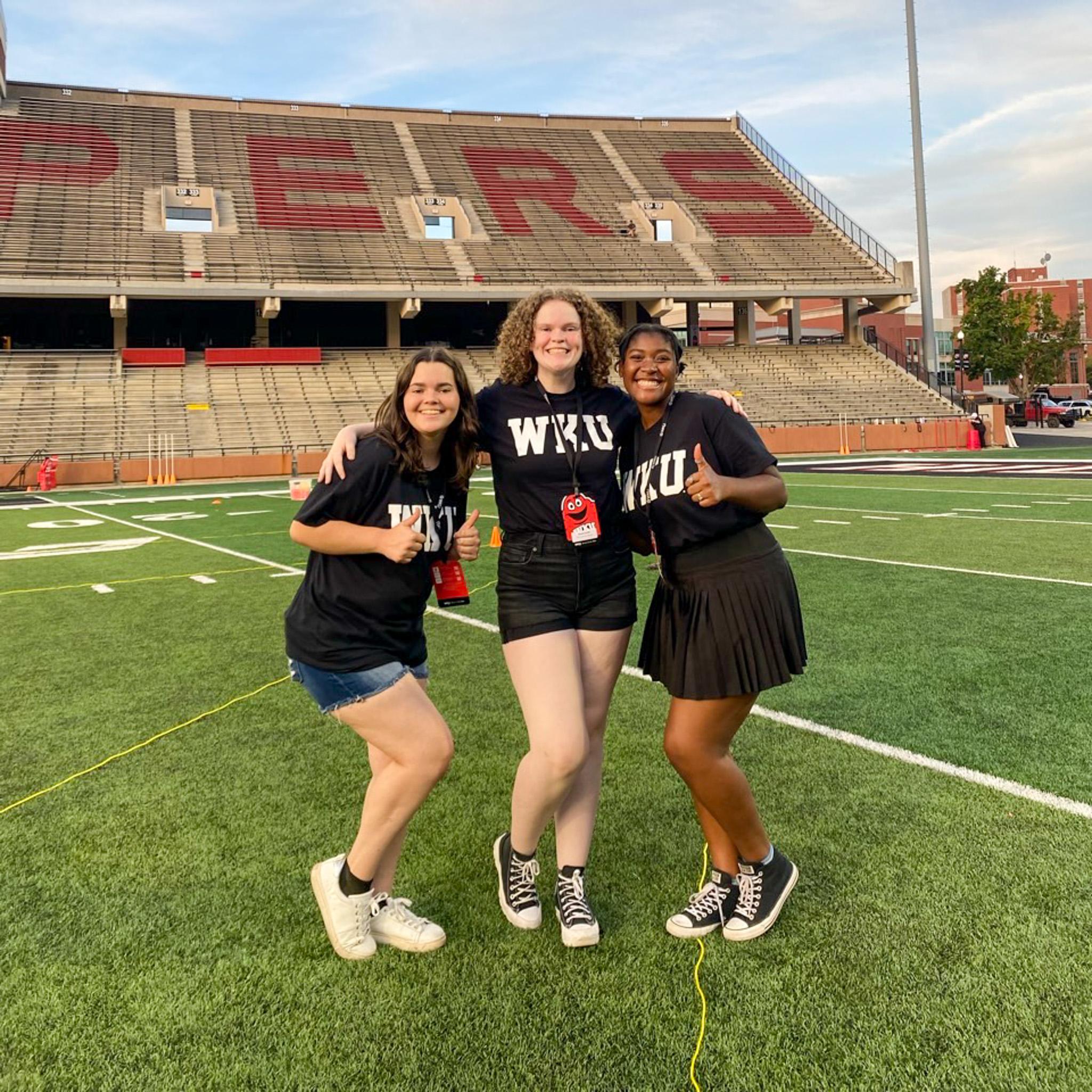 MASTER Plan Mentors smiling for a photo on the football field