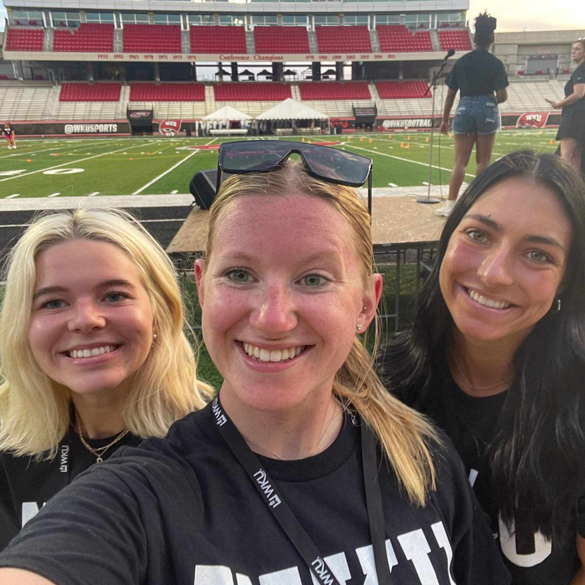 MASTER Plan Mentors smiling for a selfie on the football field