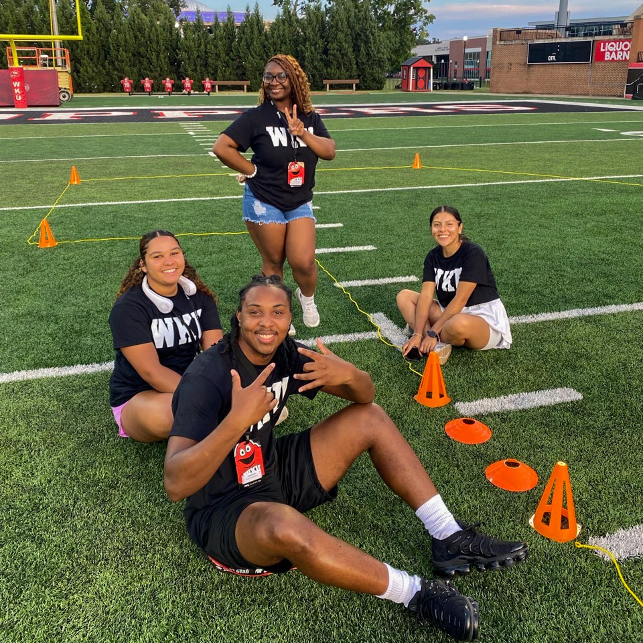 MASTER Plan Mentors smiling for a photo on the football field