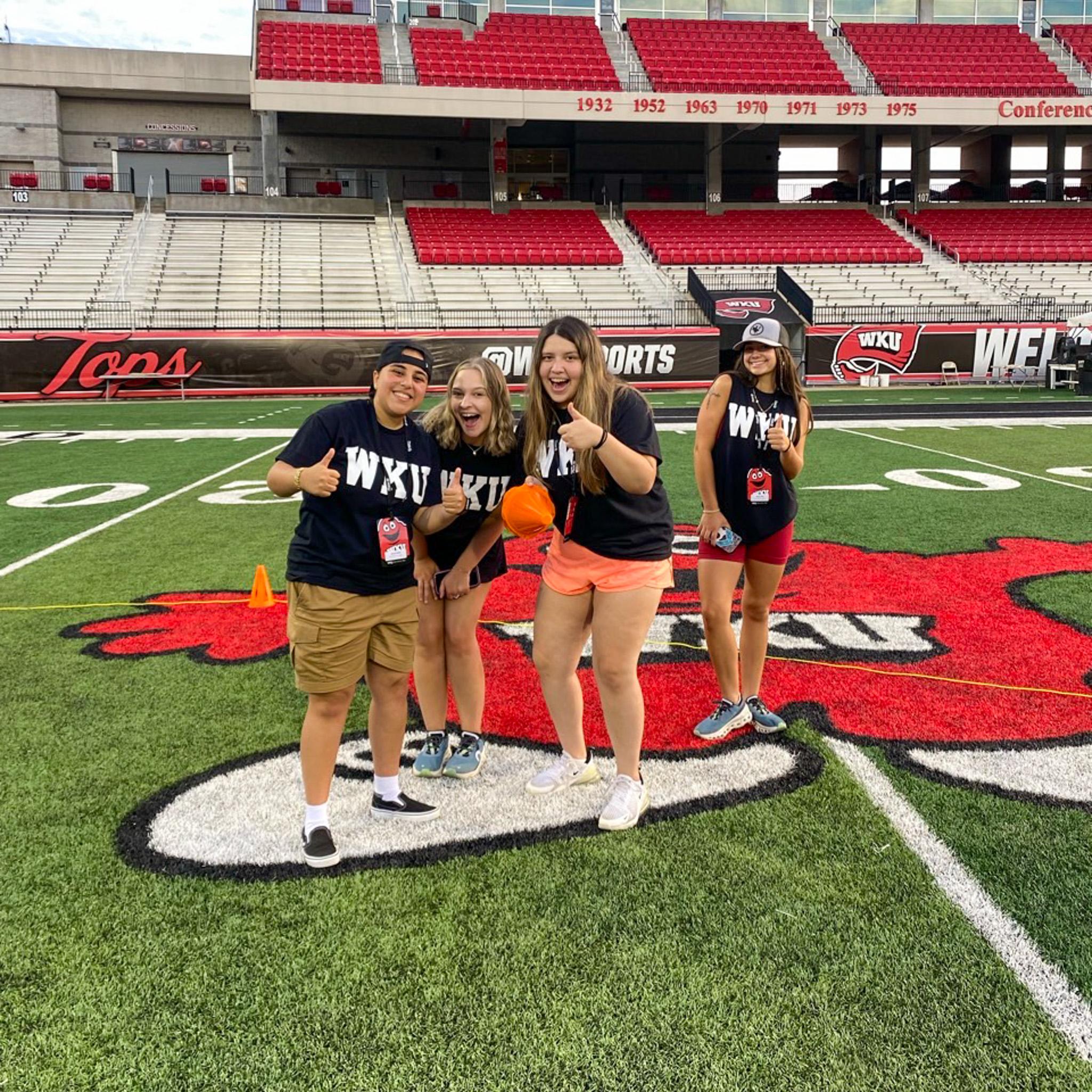 MASTER Plan Mentors smiling for a photo on the football field