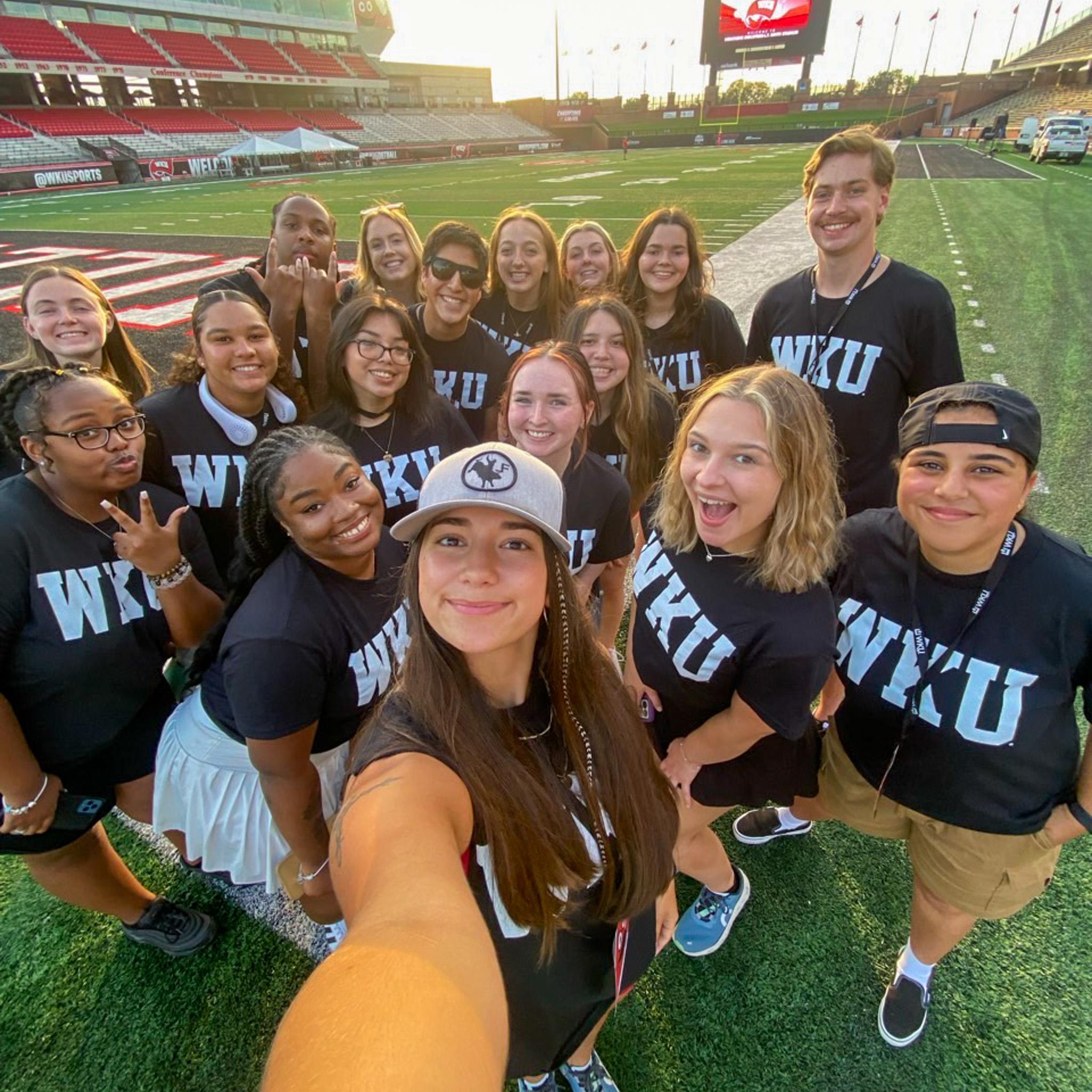 MASTER Plan Mentors smiling for a selfie on the football field