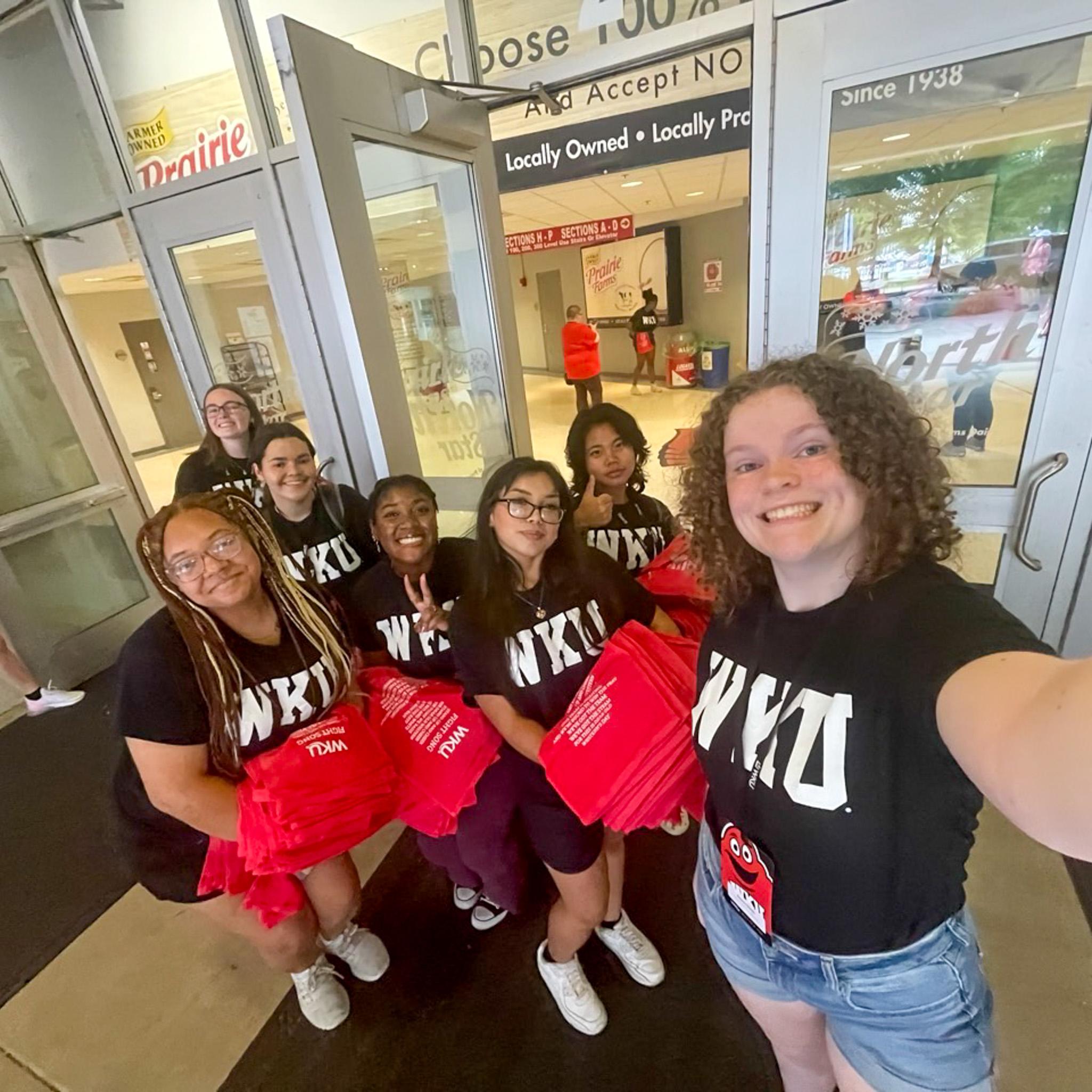 MASTER Plan Mentors smiling for a selfie while holding red towels