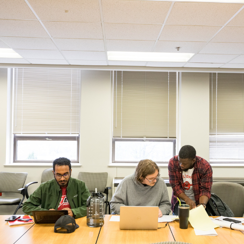 Three Master of Science in Mathematics students work together on a research presentation. 
