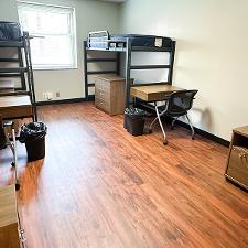 Zacharias Interior with loftable beds, moveable hanging desks, dressers, and red chairs that can join together to make a couch.