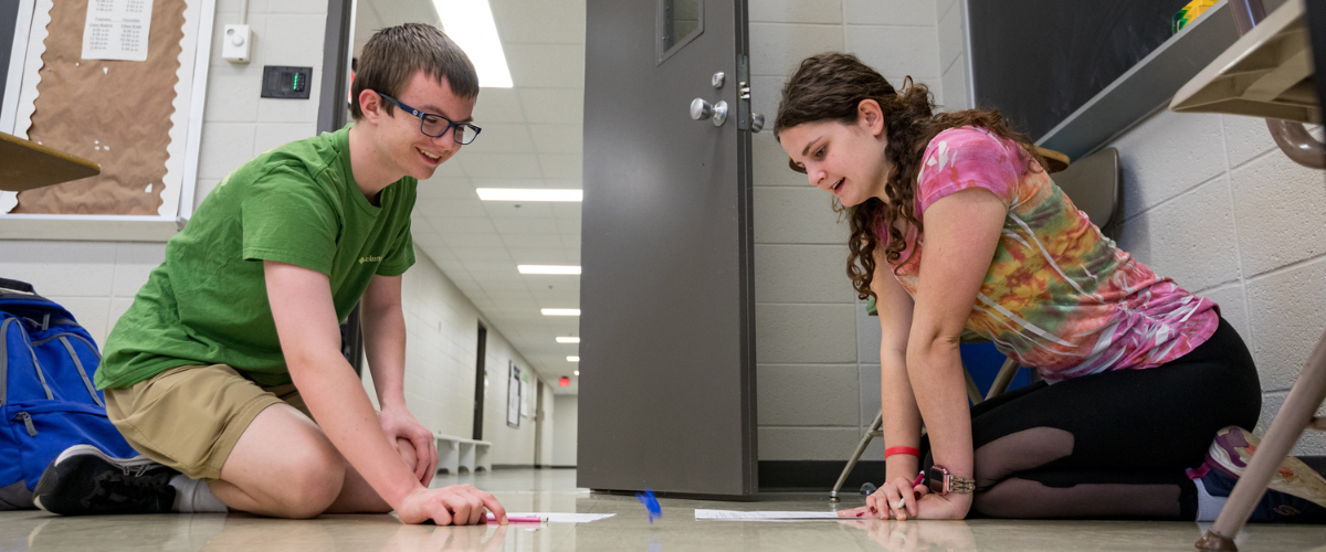 Two students work together in math class.