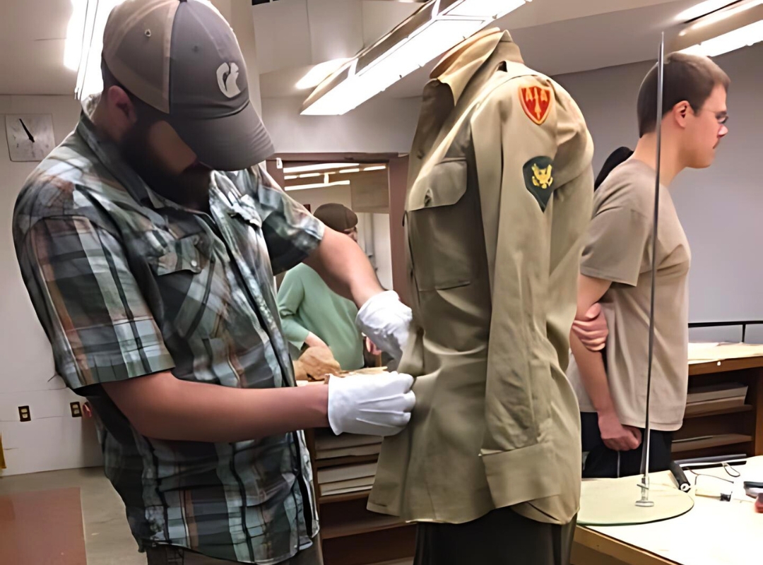 folklore student fixing war uniform