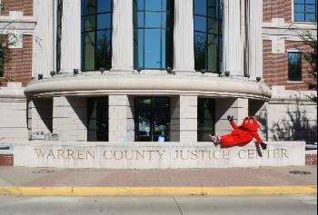 Big Red outside of Warren County Justice Center sitting on stone sign indicating the building is the Warren County Justice Center.